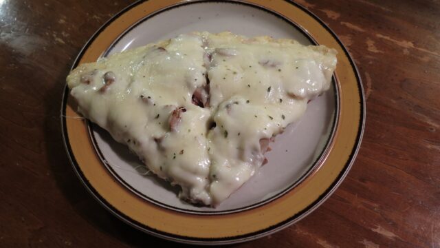 Two slices of supreme pizza on a plate; an illustration, not taken at Awesome Kitchen Pizza.