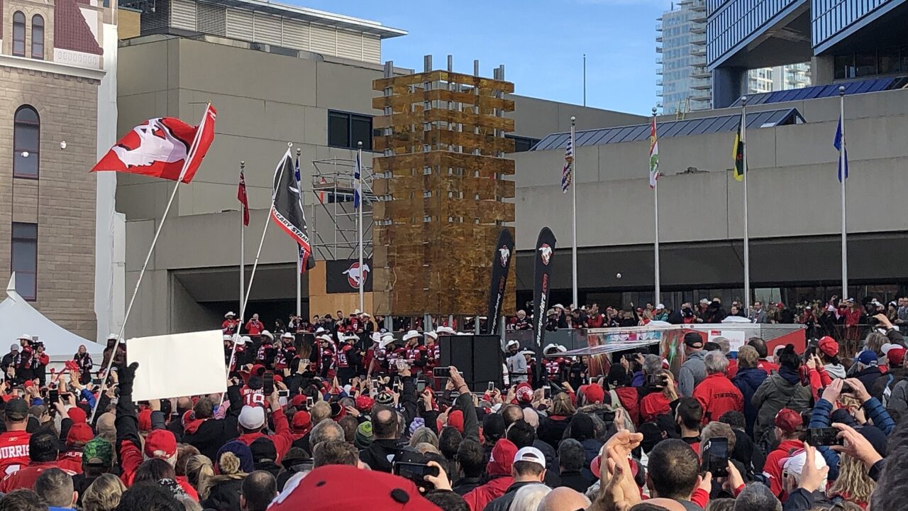 A crowd of football fans in red at the 106th Grey Cup rally in downtown Calgary on November 27 2018.