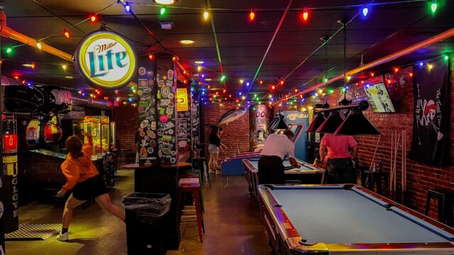 Pool tables, skee-ball machines and classic arcade games in an arcade bar; an illustration, not taken at Greta Bar.