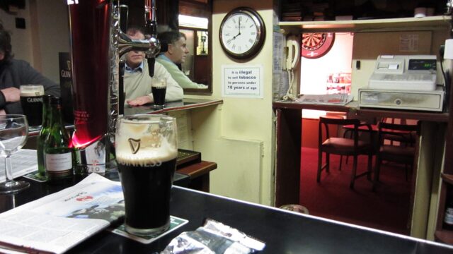 The wood-panelled interior of an Irish pub; an illustration, not taken at St. James Corner.