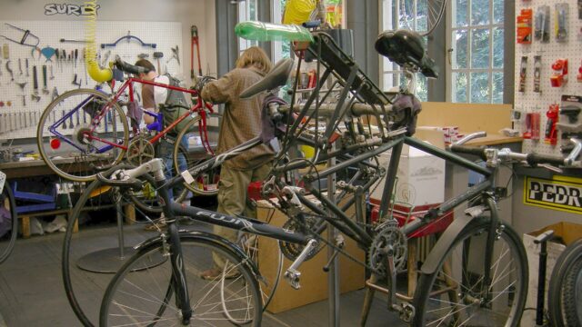 Bicycles and tools inside a bicycle repair shop in Seattle; an illustration, not taken at Velet Bike Ski Cafe.