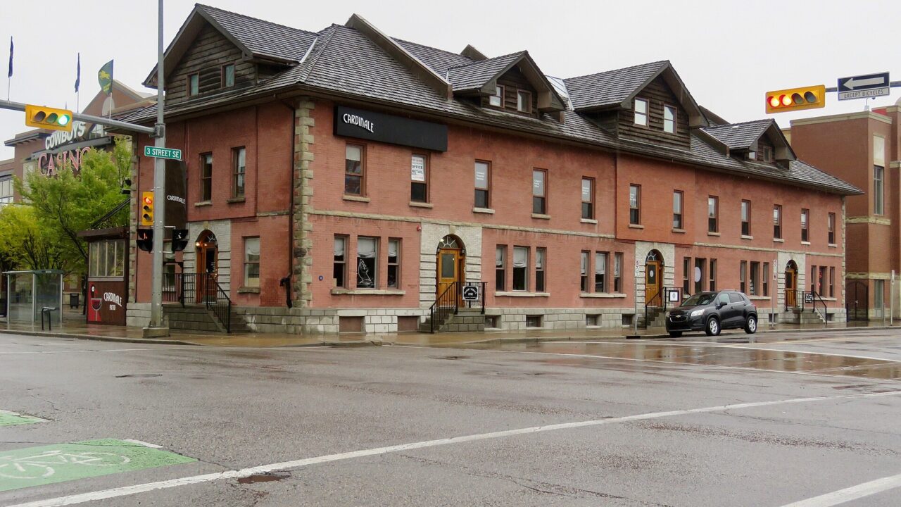 The historic red-brick Dafoe Terrace building at a street corner on the Stampede grounds in Calgary, September 2018.