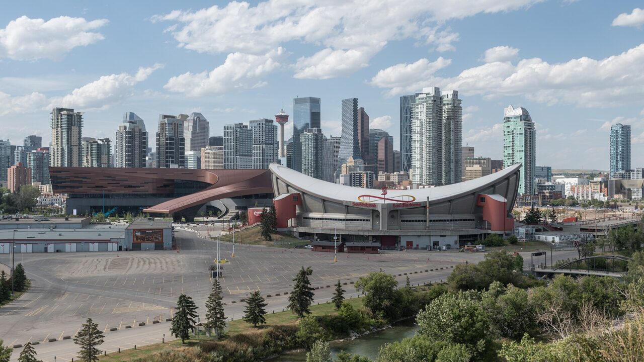 Stampede Park in Calgary with the convention centre, the saddle-shaped arena and the downtown skyline behind them, photographed in August 2024.