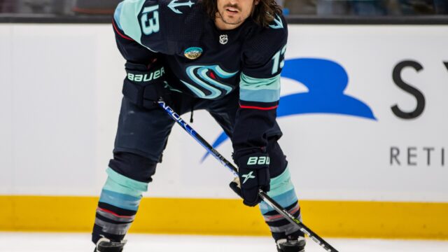 Calgary Flames and Seattle Kraken players in action during an NHL game in Seattle on November 20 2023.