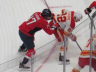Brothers Dylan Strome of the Washington Capitals and Ryan Strome of the Calgary Flames battle for position during their game on March 9 2026.