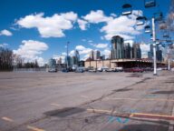 Stampede Park in Calgary with the downtown skyline behind an open lot, May 2014.
