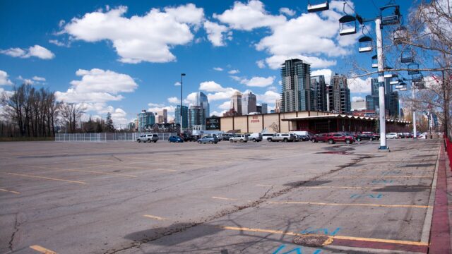 Stampede Park in Calgary with the downtown skyline behind an open lot, May 2014.