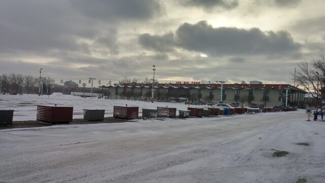 A snow-dusted Stampede Park lot under a grey winter sky in Calgary, March 2017.