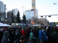 A crowd of football fans in team colours on a downtown street at the 2010 Grey Cup Festival in Edmonton.